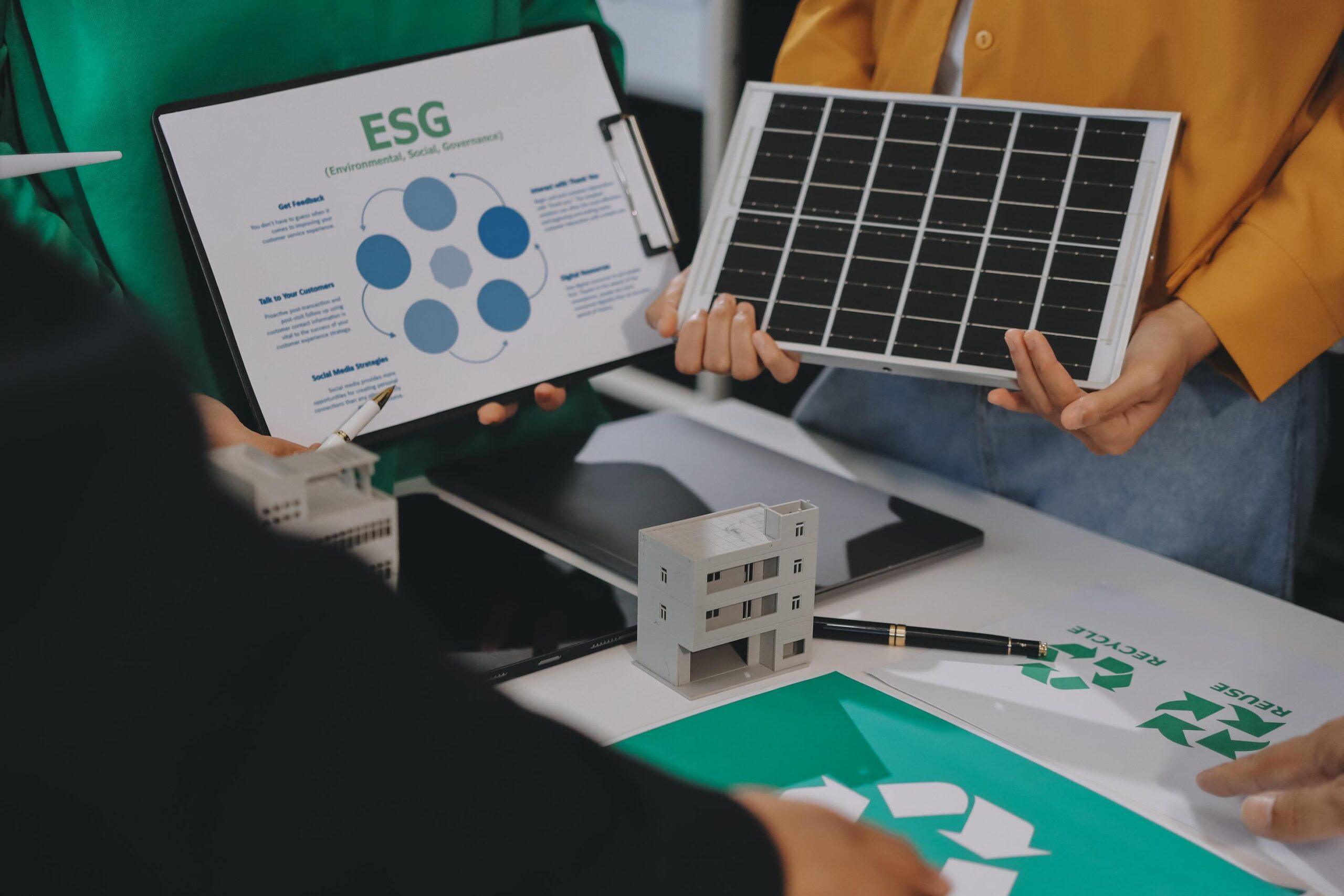 people-holding-up-a-solar-panel-and-a-paper-with-the-words-esg-on-it-free-photo